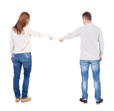 Back view of couple in sweater pointing. Rear view people collection. backside view of person. Isolated over white background.の写真素材