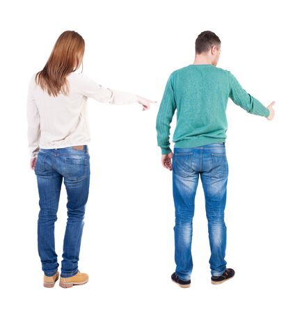 Back view of couple in sweater pointing. Rear view people collection. backside view of person. Isolated over white background.の写真素材