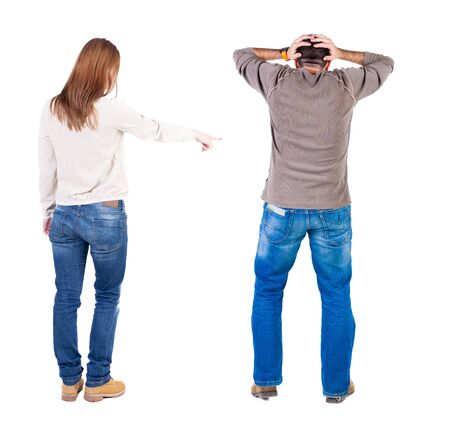 Back view of couple in sweater pointing. Rear view people collection. backside view of person. Isolated over white background.の写真素材