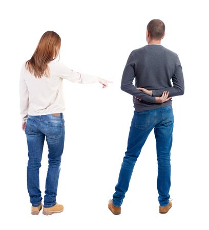 Back view of couple in sweater pointing. Rear view people collection. backside view of person. Isolated over white background.の写真素材