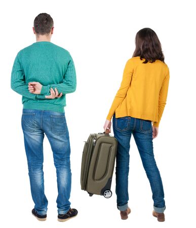 young couple in sweater traveling with suitcas. Back view. Rear view people collection. backside view of person. Isolated over white background.の写真素材