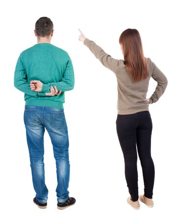 Back view of couple in sweater pointing. Rear view people collection. backside view of person. Isolated over white background.の写真素材