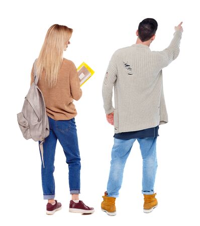Back view of couple in sweater pointing. Rear view people collection. backside view of person. Isolated over white background.の写真素材