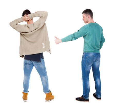 Back view two man in sweater showing thumb up. Rear view people collection. backside view of person. Isolated over white background.の写真素材