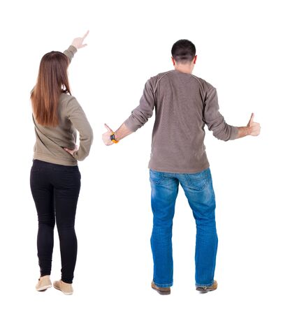 Back view of couple in sweater pointing. Rear view people collection. backside view of person. Isolated over white background.の写真素材