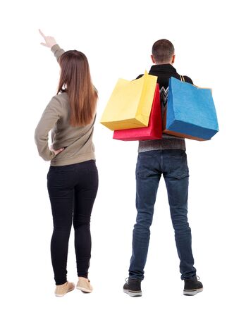 back view of couple with shopping bags. backside view of person. Rear view people collection. Isolated over white background.の写真素材