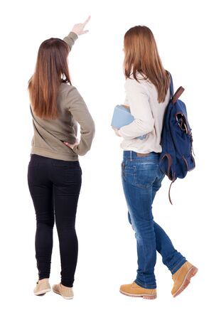 Back view of two pointing girl in sweater. Rear view people collection. backside view of person. beautiful woman showing gesture. Rear view. Isolated over white background.の写真素材