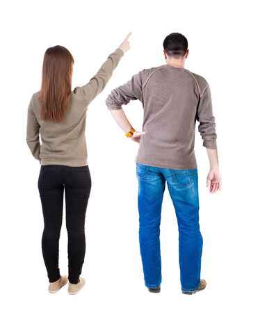 Back view of couple in sweater pointing. Rear view people collection. backside view of person. Isolated over white background.の写真素材