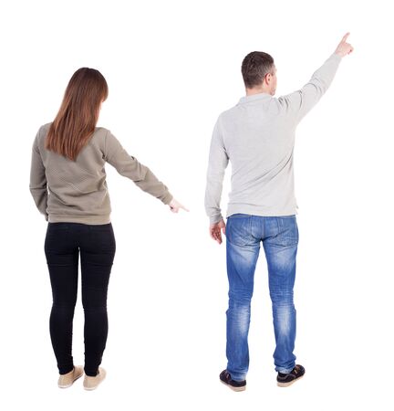 Back view of couple in sweater pointing. Rear view people collection. backside view of person. Isolated over white background.の写真素材