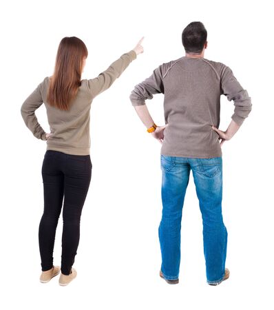Back view of couple in sweater pointing. Rear view people collection. backside view of person. Isolated over white background.の写真素材