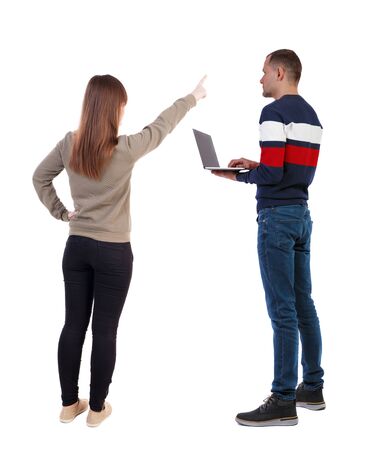Back view couple with laptop in sweater. beautiful man and woman. Rear view people collection. backside view of person. Isolated over white background.の写真素材