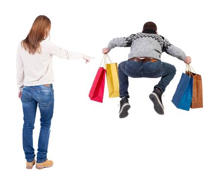 back view of couple with shopping bags. backside view of person. Rear view people collection. Isolated over white background.の写真素材