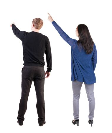 Back view of couple in sweater pointing. Rear view people collection. backside view of person. Isolated over white background.の写真素材