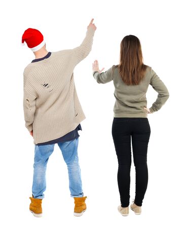 Back view of couple in sweater pointing. Rear view people collection. backside view of person. Isolated over white background.の写真素材