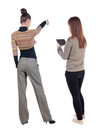 Back view of two pointing girl in sweater. Rear view people collection. backside view of person. beautiful woman showing gesture. Rear view. Isolated over white background.の写真素材