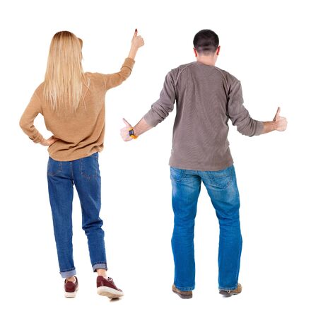 Back view of couple in sweater showing thumbs up. beautiful woman and man together. Rear view people collection. backside view of person. Isolated over white background.の写真素材