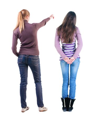 Back view of two pointing girl in sweater. Rear view people collection. backside view of person. beautiful woman showing gesture. Rear view. Isolated over white background.の写真素材