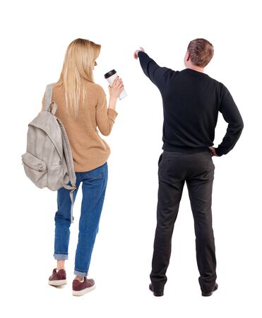 Back view of couple in sweater pointing. Rear view people collection. backside view of person. Isolated over white background.の写真素材