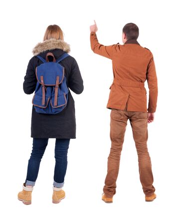 Back view of two pointing girl in winter jacket. Rear view people collection. backside view of person. beautiful woman friends showing gesture. Rear view. Isolated over white background.の写真素材