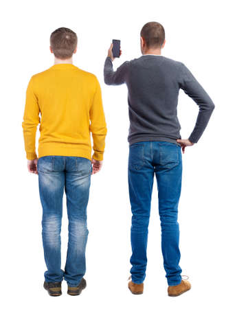 Back view of two man in sweater with mobile phone. Rear view people collection. backside view of person. Isolated over white background.の写真素材