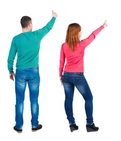 Back view of couple in sweater pointing. Rear view people collection. backside view of person. Isolated over white background.の写真素材