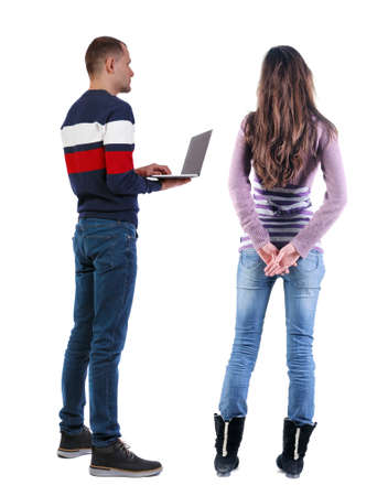 Back view couple with laptop in sweater. beautiful man and woman. Rear view people collection. backside view of person. Isolated over white background.の写真素材