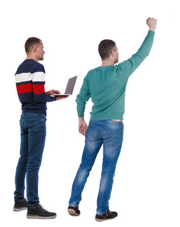 Back view two man in sweater with laptop. Rear view people collection. backside view of person. Isolated over white background. Guys looking forwardの写真素材