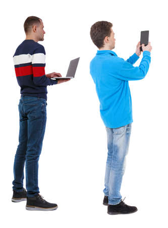 Back view two man in sweater with laptop. Rear view people collection. backside view of person. Isolated over white background. Guys looking forwardの写真素材