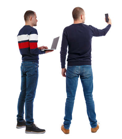 Back view two man in sweater with laptop. Rear view people collection. backside view of person. Isolated over white background. Guys looking forwardの写真素材