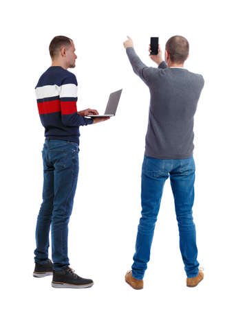 Back view two man in sweater with laptop. Rear view people collection. backside view of person. Isolated over white background. Guys looking forwardの写真素材