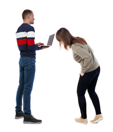 Back view couple with laptop in sweater. beautiful man and woman. Rear view people collection. backside view of person. Isolated over white background.の写真素材