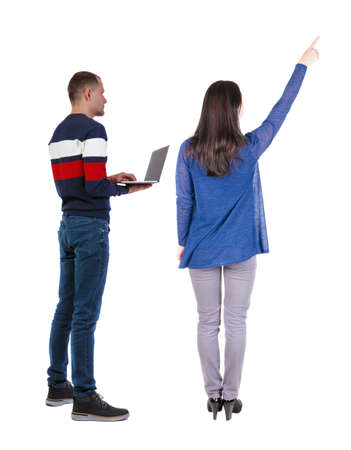 Back view couple with laptop in sweater. beautiful man and woman. Rear view people collection. backside view of person. Isolated over white background.の写真素材