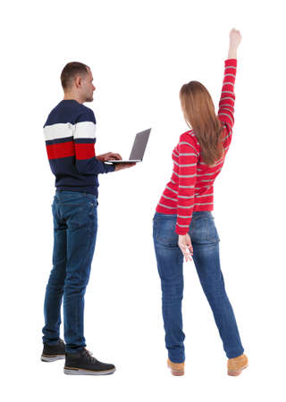 Back view couple with laptop in sweater. beautiful man and woman. Rear view people collection. backside view of person. Isolated over white background.の写真素材