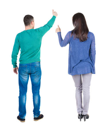 Back view of couple in sweater showing thumbs up. beautiful woman and man together. Rear view people collection. backside view of person. Isolated over white background.の写真素材