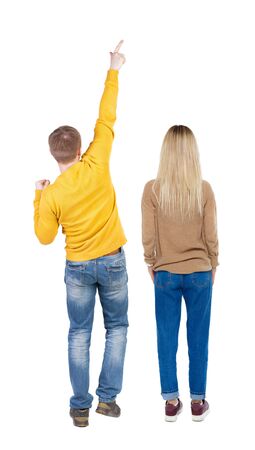 Back view of couple in sweater pointing. Rear view people collection. backside view of person. Isolated over white background.の写真素材