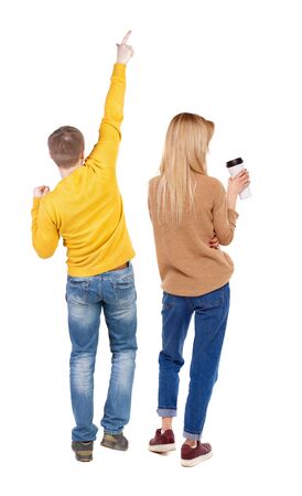 Back view of couple in sweater pointing. Rear view people collection. backside view of person. Isolated over white background.の写真素材