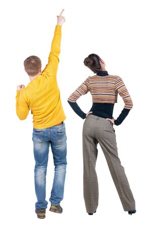 Back view of couple in sweater pointing. Rear view people collection. backside view of person. Isolated over white background.の写真素材