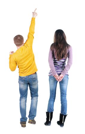 Back view of couple in sweater pointing. Rear view people collection. backside view of person. Isolated over white background.の写真素材