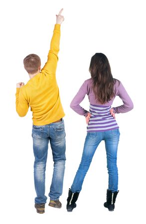 Back view of couple in sweater pointing. Rear view people collection. backside view of person. Isolated over white background.の写真素材