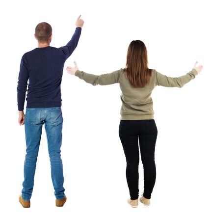 Back view of couple in sweater pointing. Rear view people collection. backside view of person. Isolated over white background.の写真素材