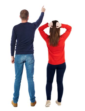 Back view of couple in sweater pointing. Rear view people collection. backside view of person. Isolated over white background.の写真素材