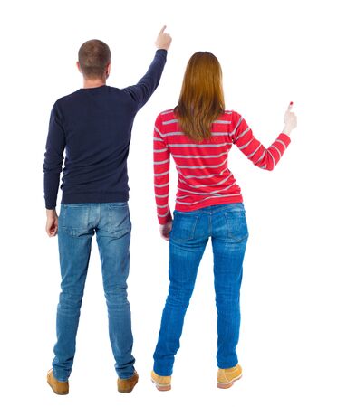 Back view of couple in sweater pointing. Rear view people collection. backside view of person. Isolated over white background.の写真素材