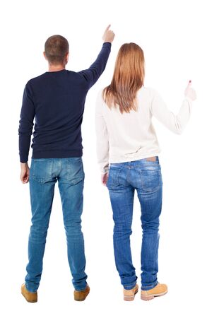 Back view of couple in sweater pointing. Rear view people collection. backside view of person. Isolated over white background.の写真素材