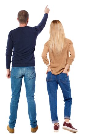 Back view of couple in sweater pointing. Rear view people collection. backside view of person. Isolated over white background.の写真素材