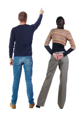 Back view of couple in sweater pointing. Rear view people collection. backside view of person. Isolated over white background.の写真素材