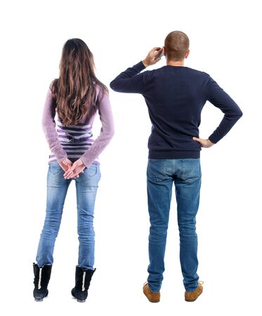 Back view of couple in sweater with mobile phone. beautiful friendly girl and guy together. Rear view people collection. backside view of person. Isolated over white background.の写真素材