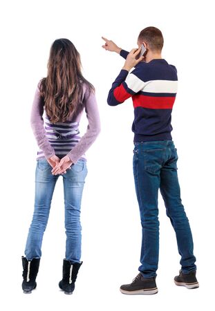 Back view of couple in sweater with mobile phone. beautiful friendly girl and guy together. Rear view people collection. backside view of person. Isolated over white background.の写真素材