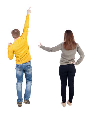 Back view of couple in sweater pointing. Rear view people collection. backside view of person. Isolated over white background.の写真素材
