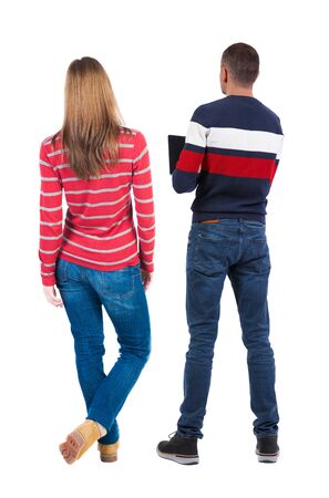Back view couple with laptop in sweater. beautiful man and woman. Rear view people collection. backside view of person. Isolated over white background.の写真素材