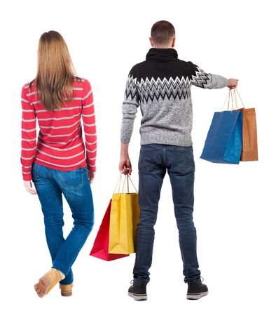 back view of couple with shopping bags. backside view of person. Rear view people collection. Isolated over white background.の写真素材